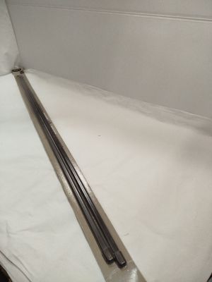 a long metal rod on a white sheet in a room