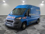 la photo d'une camionnette bleue garée sur un sol en damier