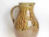 two vases sitting next to each other on a white surface