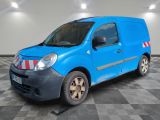 the small blue van is parked in a large room