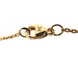 a close up of a gold chain bracelet with a letter on it