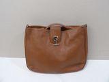 a brown leather purse with a metal clasp on the handle