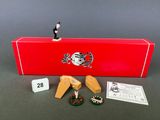 an assortment of miniature figurines including a red box and a small figurine