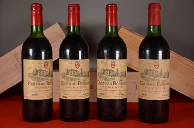 three bottles of red wine sitting on a table next to a wooden box