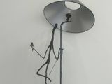 sculpture of a person holding a lamp on a table