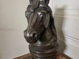 a statue of a horse that is sitting on a rug