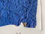 an image of a piece of blue paper with a black cat on it