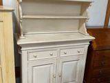 une armoire blanche et une commode dans une pièce