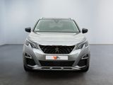 the front view of a silver car in a white room