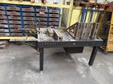 a table with a bunch of tools on it in a warehouse