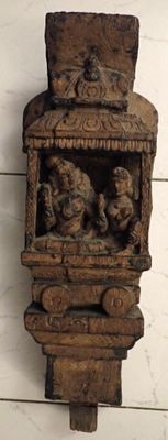 a wooden wall hanging with carvings of animals on it