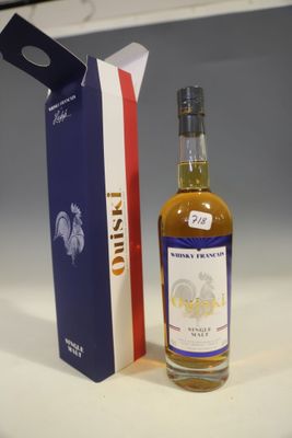 a bottle of whisky next to a box on a table