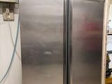 a stainless steel double door refrigerator in a kitchen