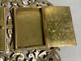 a gold picture frame with a book on top of it