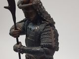 a statue of a man in armor holding a staff