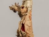 a small doll that is standing on a table