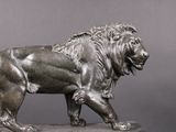 a statue of a lion that is standing on a pedestal