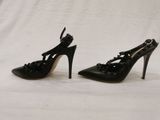 black high heeled shoes with bows and bows on the toes