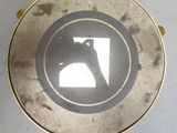 a gold plate with a picture of a man on it