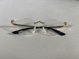 pair of glasses on a table with a white background