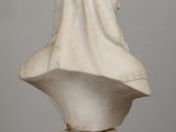 a white marble bust of a woman with a veil on her head
