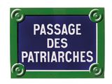 blue and white sign with green border saying passage des patriaches