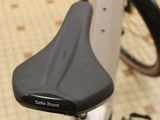 a close up of a bicycle seat with a bike in the background