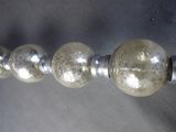 a close up of a silver bead on a curtain