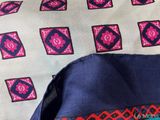 a close up of a tie with a design on it