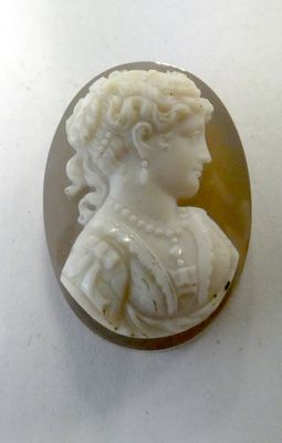 an image of a woman ' s profile is shown in a carved shell