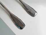 two spoons and a fork on a table