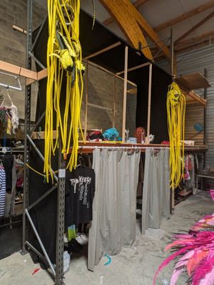 a room with a lot of clothes hanging on a rack