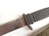 a knife that is laying on the ground next to a knife