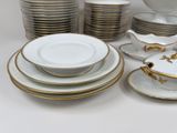 a lot of plates and bowls that are sitting on a table