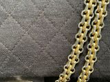 a close up of a purse with a chain on it
