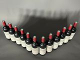 a group of bottles of wine sit in a row on a table