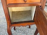 a small table with a drawer on top of it