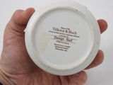 a person holding a white bowl with a label on it