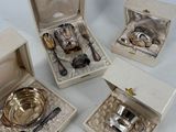 four pieces of silverware sitting in a box on a white surface