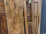 several pieces of wood sit on the floor in front of a door