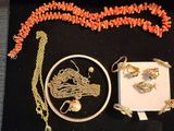 a box with a necklace, bracelet, ring, and other jewelry