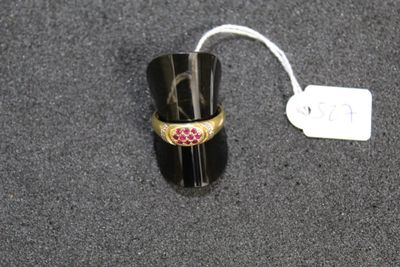 a black ring with a pink stone on it and a price tag