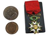 a medal and a coin sitting next to each other