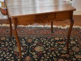 a small wooden table with a drawer on top of it