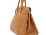 a brown leather handbag on a white background