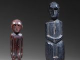 three carved wooden figures of a man and a woman