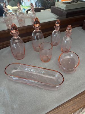 bottles and glasses on a table with a mirror in the background
