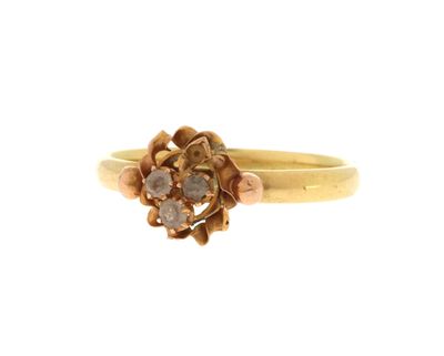 un gros plan d'une bague en or ornée d'un motif floral