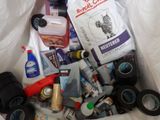 a bag full of toiletries and cleaning supplies on a bed