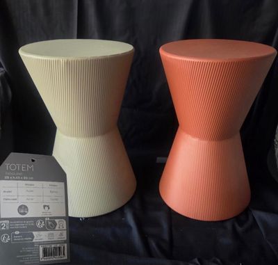 two different colored stools sitting next to each other